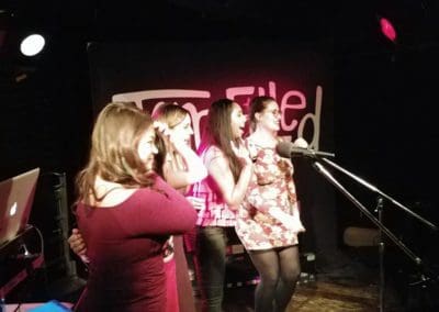 Guests singing karaoke on stage at the Rivoly during a Disc Jockeys Unlimited event
